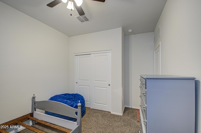 bedroom with ceiling fan, visible vents, baseboards, a closet, and carpet