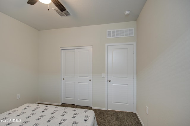 unfurnished bedroom with carpet, a closet, visible vents, and baseboards