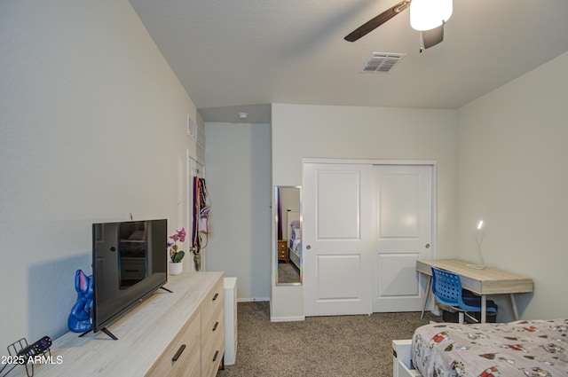 bedroom featuring a ceiling fan, a closet, visible vents, and carpet flooring