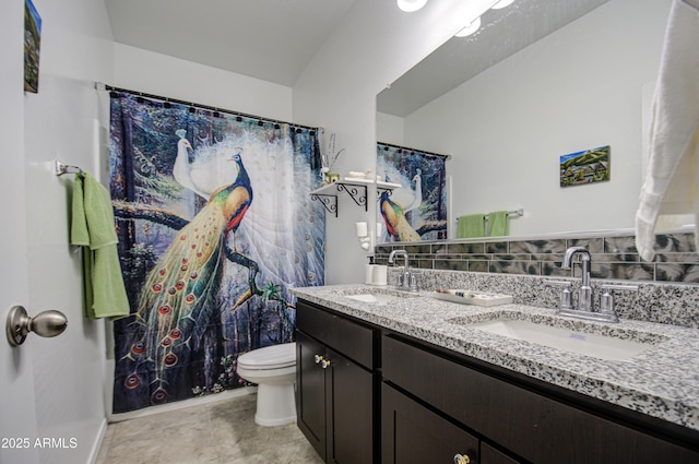 full bathroom featuring a sink, toilet, and double vanity