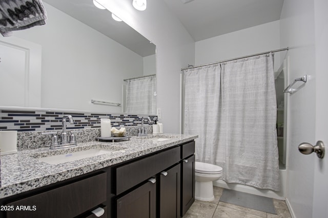 full bath featuring tasteful backsplash, a sink, toilet, and double vanity