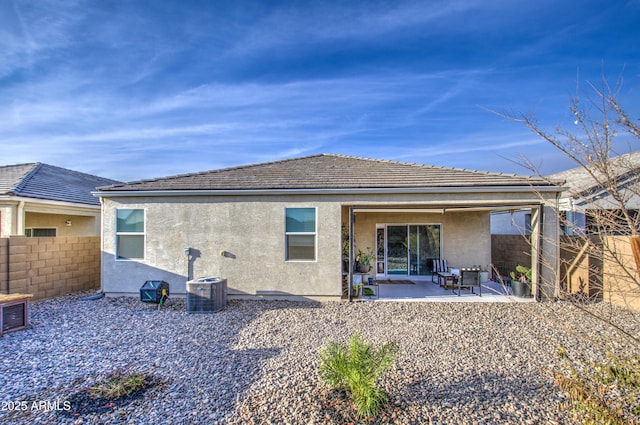 rear view of property with a patio area, fence, cooling unit, and stucco siding