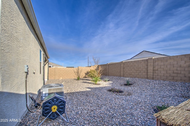 view of yard featuring a fenced backyard and central air condition unit