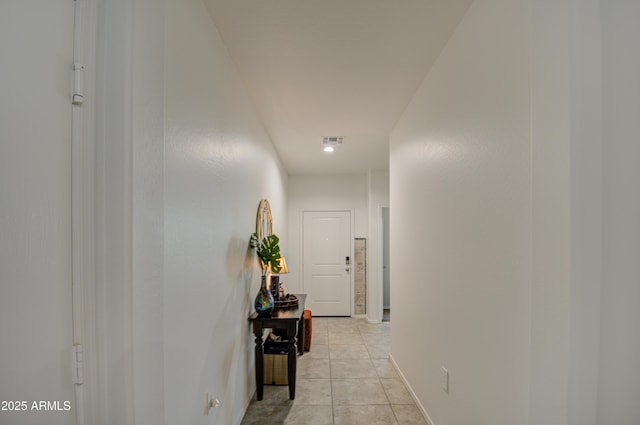 hall featuring light tile patterned floors and visible vents