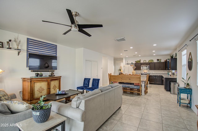 living area with a ceiling fan, recessed lighting, visible vents, and light tile patterned floors