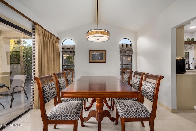 dining area featuring beamed ceiling, light tile patterned floors, and high vaulted ceiling