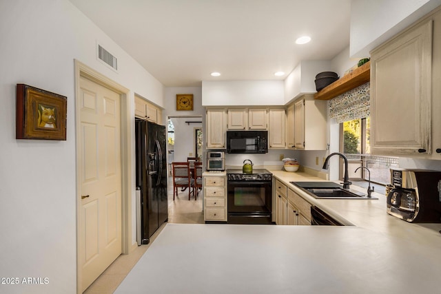 kitchen featuring kitchen peninsula, sink, and black appliances