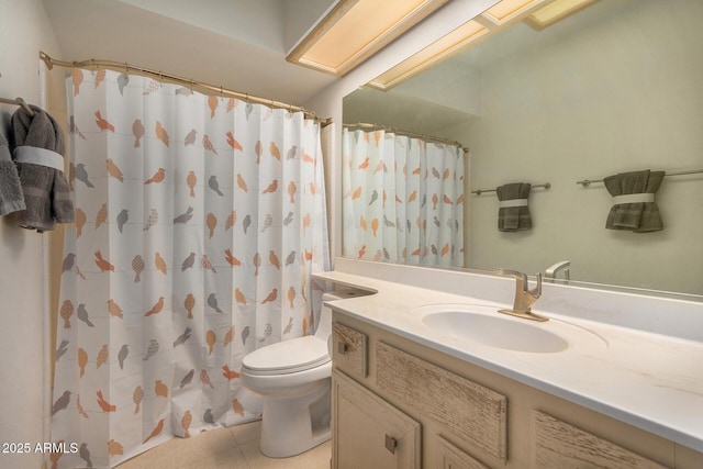 bathroom with curtained shower, vanity, and toilet