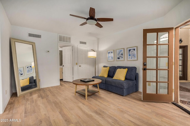 living room with light wood-type flooring and ceiling fan