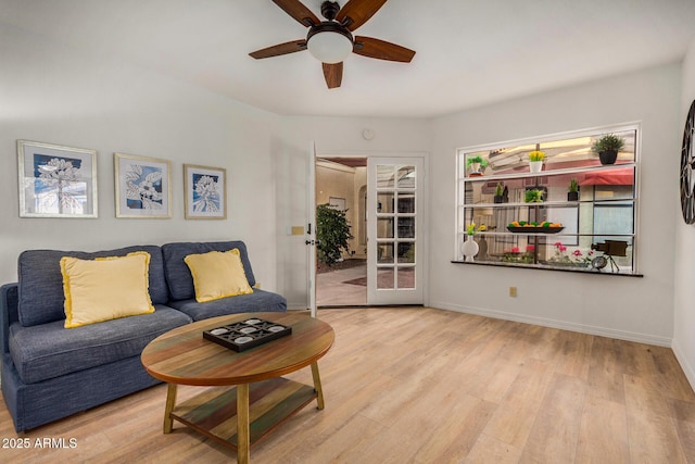 living room featuring ceiling fan and light hardwood / wood-style floors