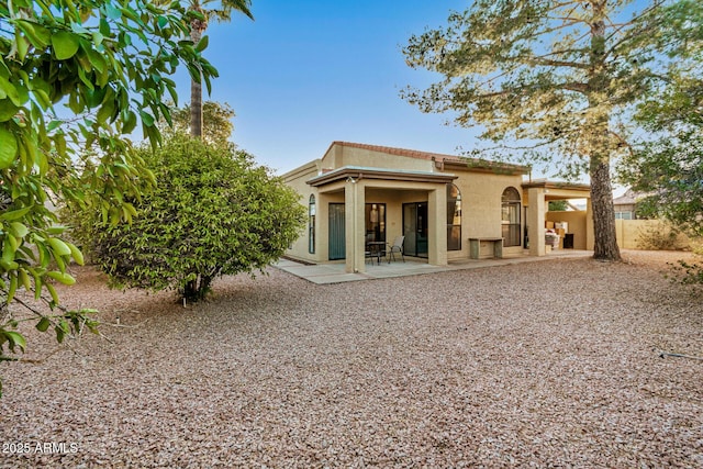 rear view of property featuring a patio area