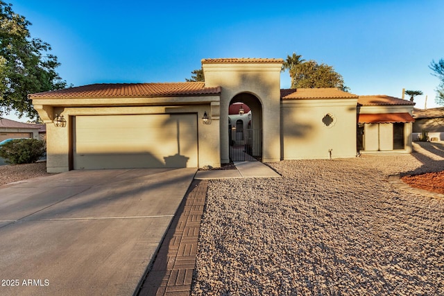 mediterranean / spanish home featuring a garage