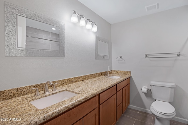 bathroom with toilet, tile patterned flooring, and vanity