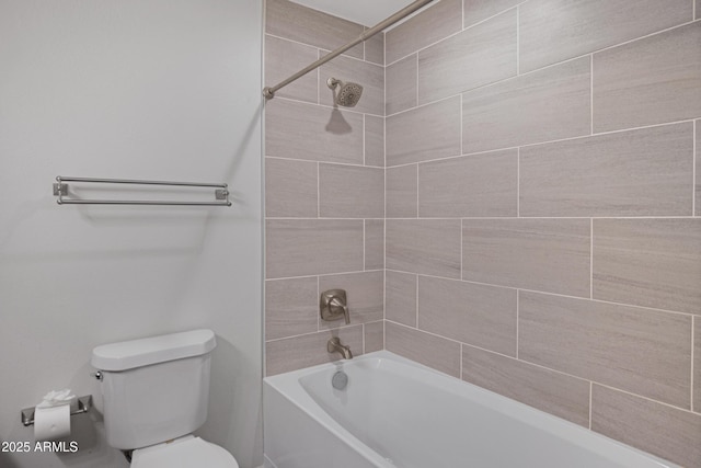 bathroom featuring toilet and tiled shower / bath combo