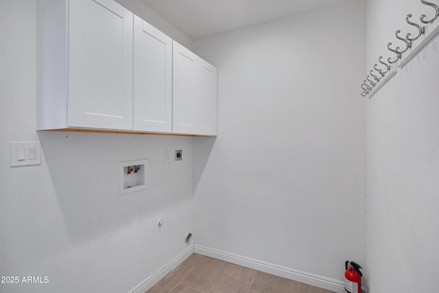 laundry area featuring washer hookup, cabinets, electric dryer hookup, and hookup for a gas dryer