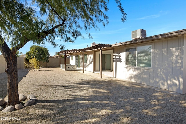 back of property featuring a pergola, central AC, and a patio area