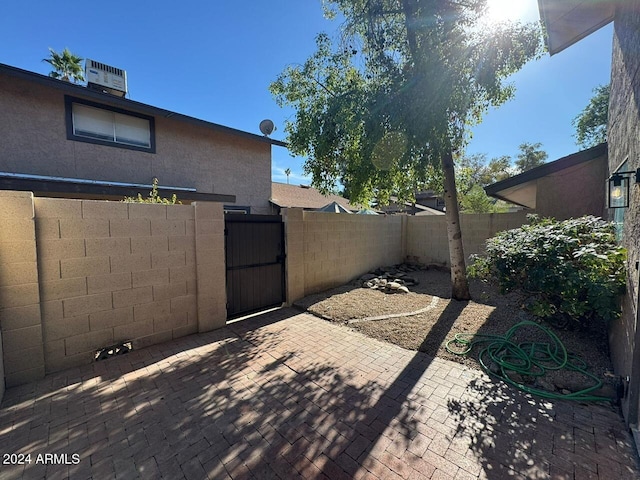 view of patio with a gate and fence