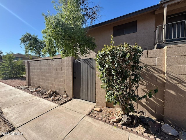 view of gate with fence