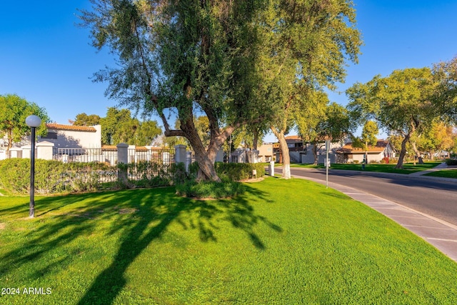 view of yard featuring fence and a residential view