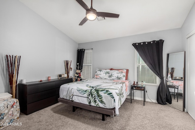 bedroom with carpet flooring, vaulted ceiling, and ceiling fan