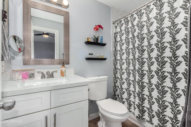 bathroom featuring vanity, toilet, and walk in shower