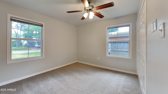 2408 W Saint Kateri Dr, Phoenix, AZ 85041 - carpeted empty room featuring baseboards, ceiling fan, and a healthy amount of sunlight