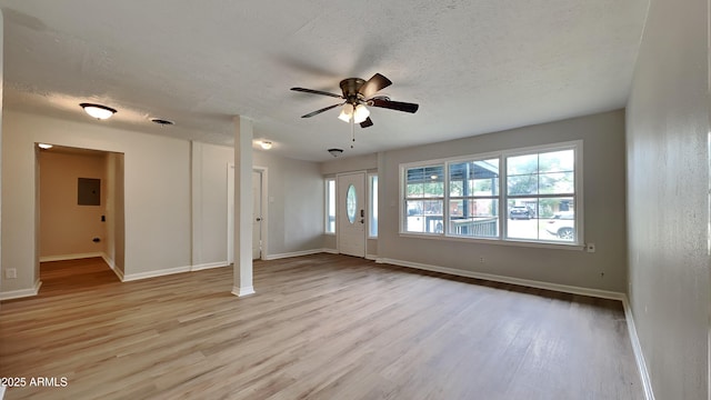 2408 W Saint Kateri Dr, Phoenix, AZ 85041 - unfurnished living room with a textured ceiling, ceiling fan, baseboards, and wood finished floors