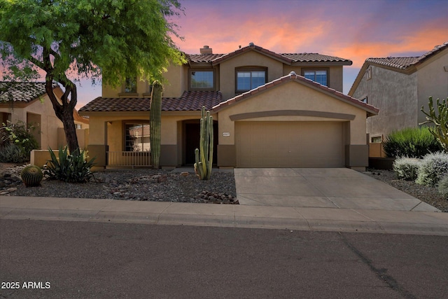 10329 E Star Of The Desert Dr, Scottsdale, AZ 85255 - mediterranean / spanish home with stucco siding, a garage, driveway, and a tiled roof