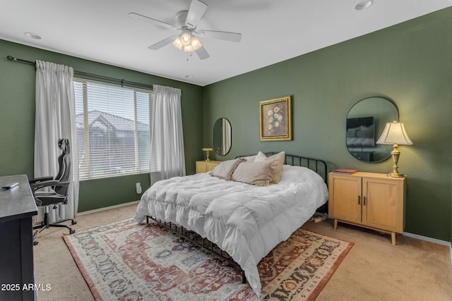 bedroom with light colored carpet, baseboards, and ceiling fan