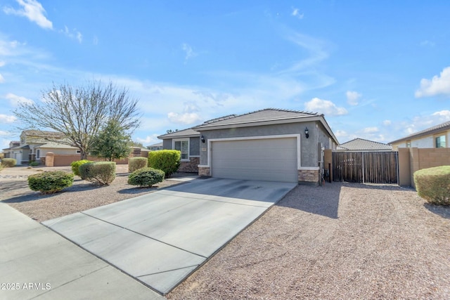 view of front of house with fence, an attached garage, stucco siding, concrete driveway, and stone siding