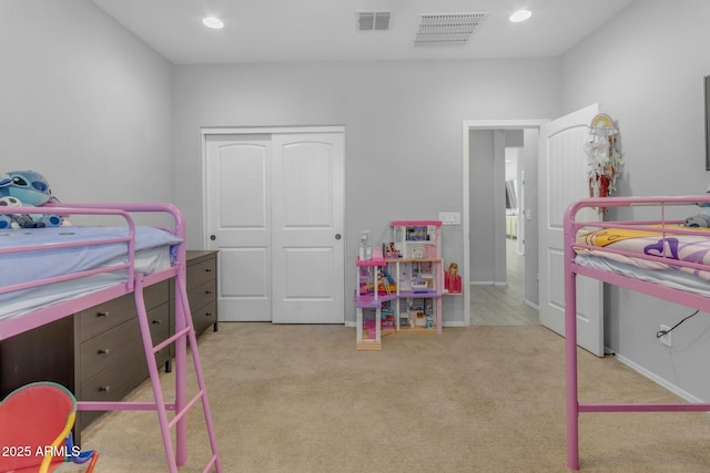 carpeted bedroom featuring recessed lighting, visible vents, and a closet