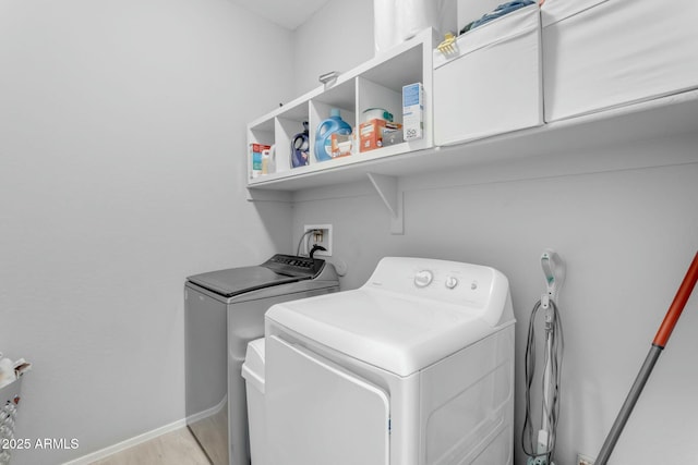 washroom with washer and clothes dryer, laundry area, and baseboards