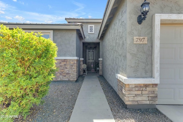 entrance to property with stone siding and stucco siding