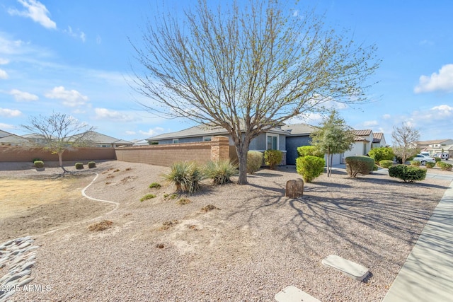 view of front of house featuring a residential view, stucco siding, and fence