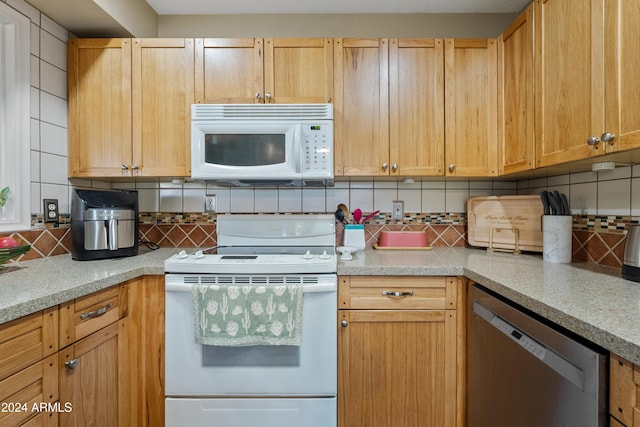 kitchen with tasteful backsplash, white appliances, and light brown cabinetry