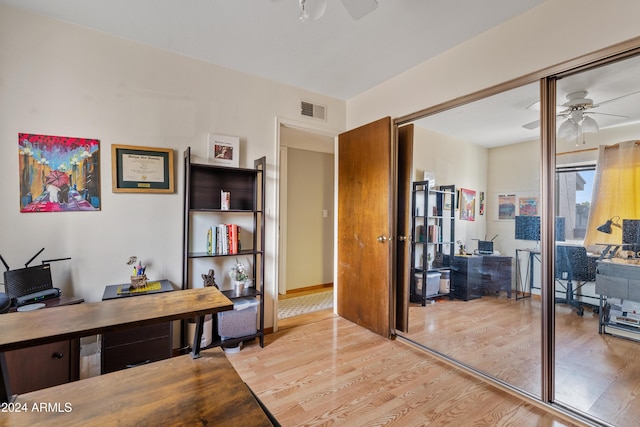 home office featuring ceiling fan and light hardwood / wood-style floors