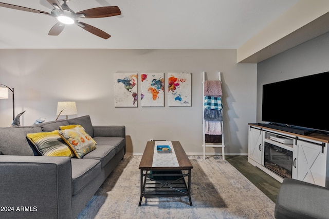 living room featuring dark hardwood / wood-style floors and ceiling fan