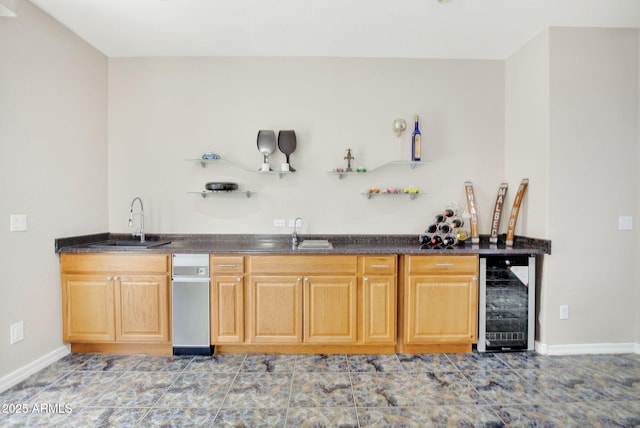 bar with wine cooler, indoor wet bar, a sink, and baseboards