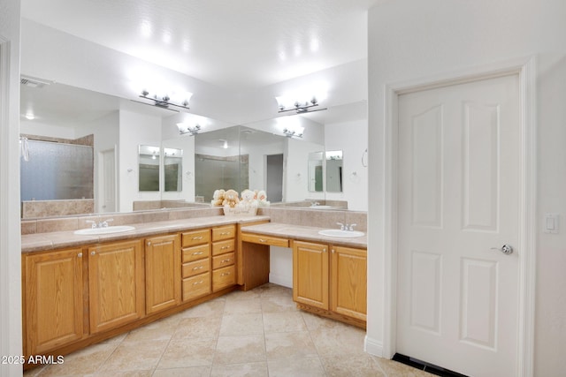 bathroom with double vanity, visible vents, a stall shower, a sink, and tile patterned flooring