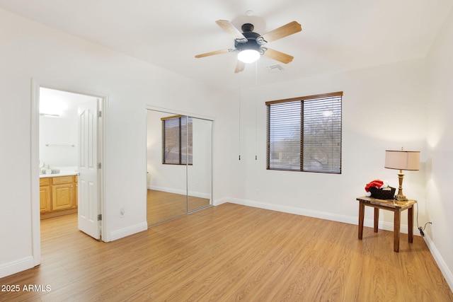 bedroom featuring baseboards and light wood finished floors