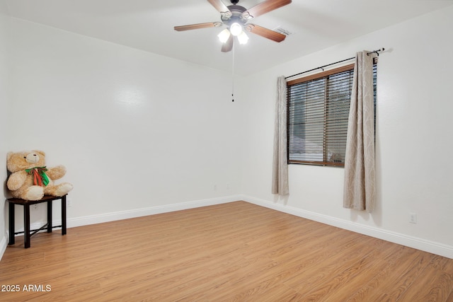 unfurnished room with light wood-style flooring and baseboards