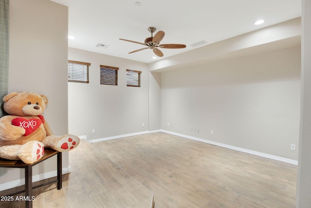 unfurnished room with light wood-style flooring, recessed lighting, a ceiling fan, visible vents, and baseboards