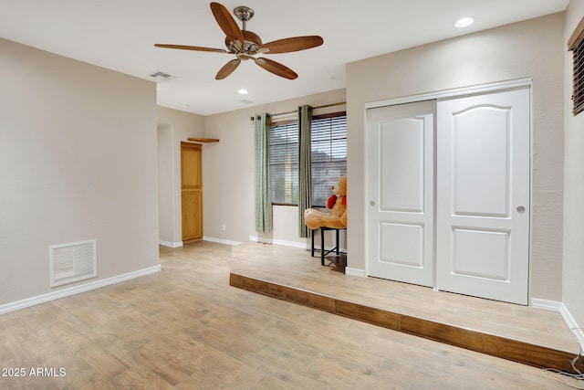 interior space featuring light wood-type flooring, baseboards, visible vents, and recessed lighting