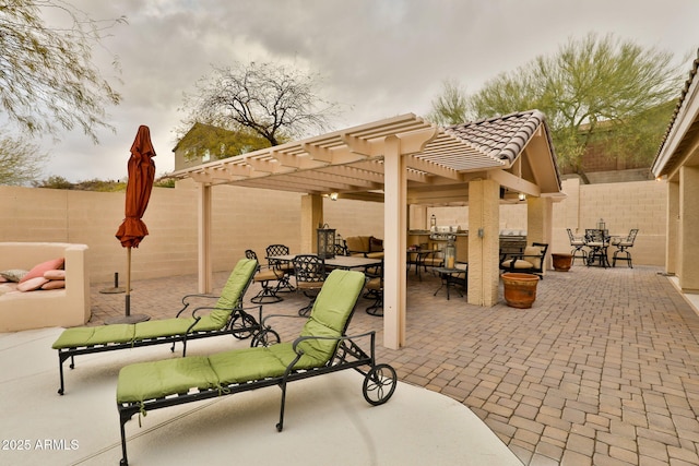 view of patio featuring outdoor dining area, a fenced backyard, and a pergola