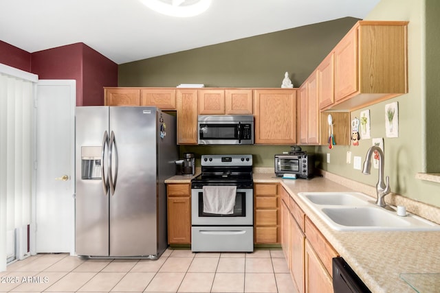 kitchen with a sink, light countertops, stainless steel appliances, lofted ceiling, and a toaster