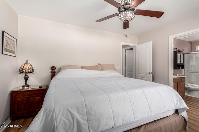 bedroom featuring a ceiling fan, connected bathroom, and wood finished floors