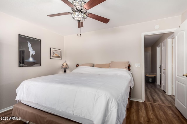 bedroom with baseboards, a ceiling fan, and wood finished floors