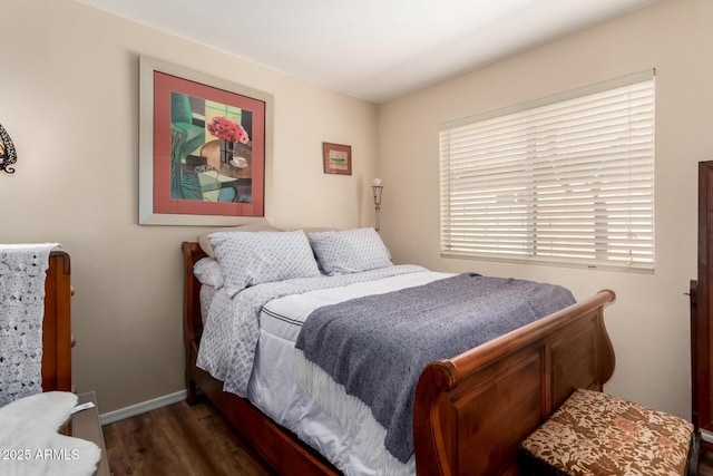 bedroom featuring baseboards and wood finished floors