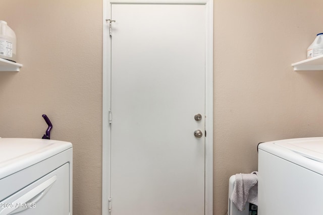 washroom featuring laundry area and washer and dryer