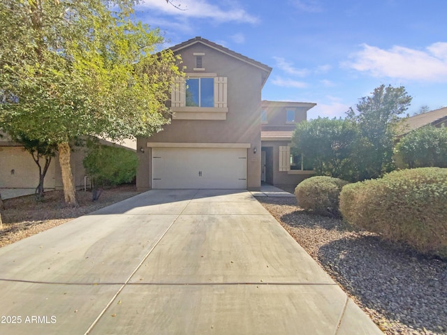 traditional home featuring stucco siding, concrete driveway, and an attached garage